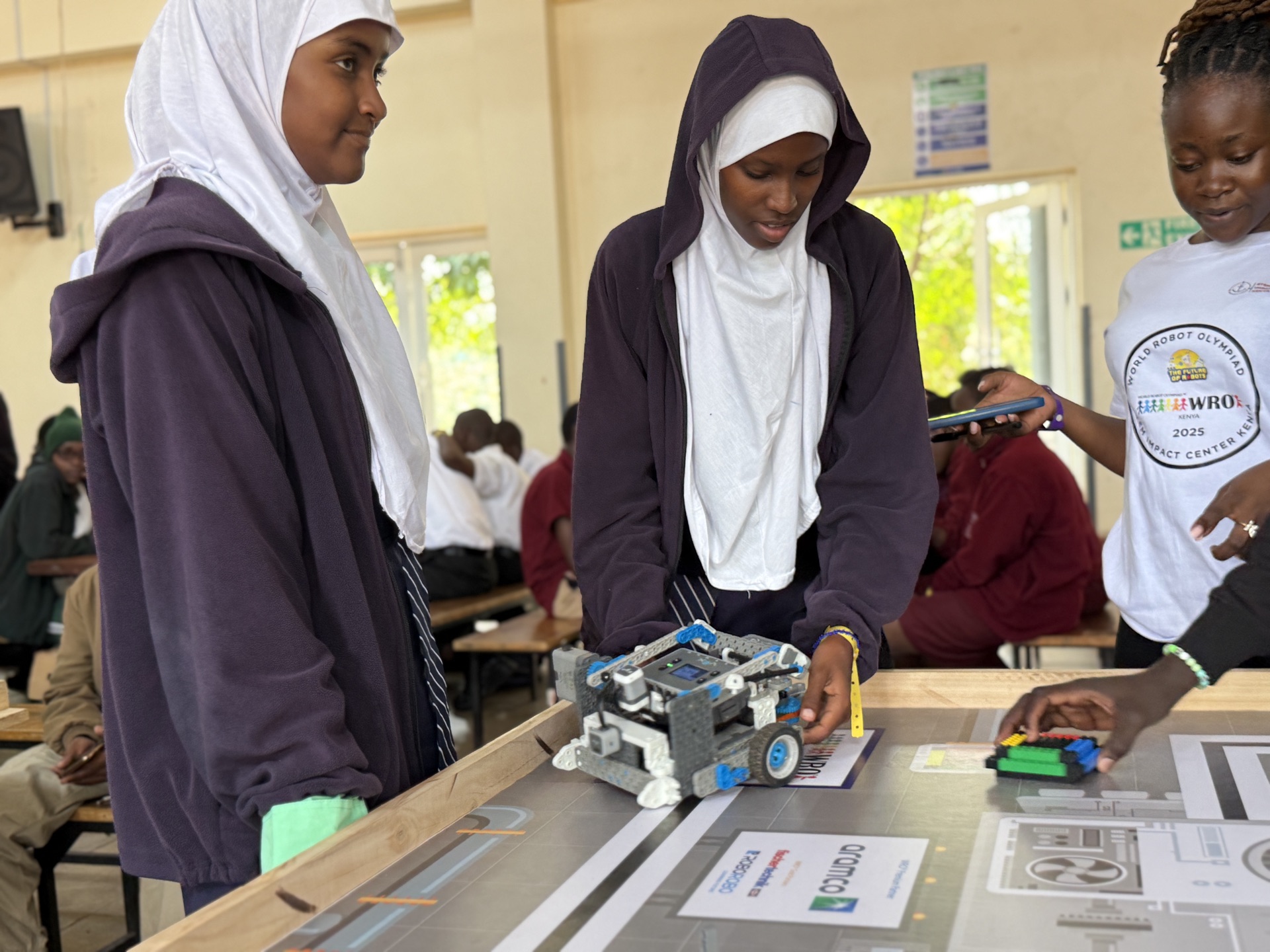 Girls testing robot at STEM competition